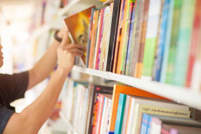 Men are reading books in the library.